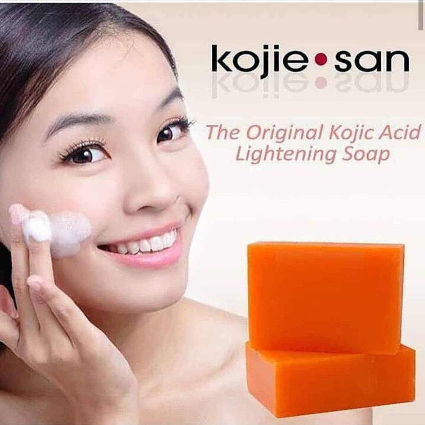 Kojie San soap with a woman applying soap to her face on a beige background