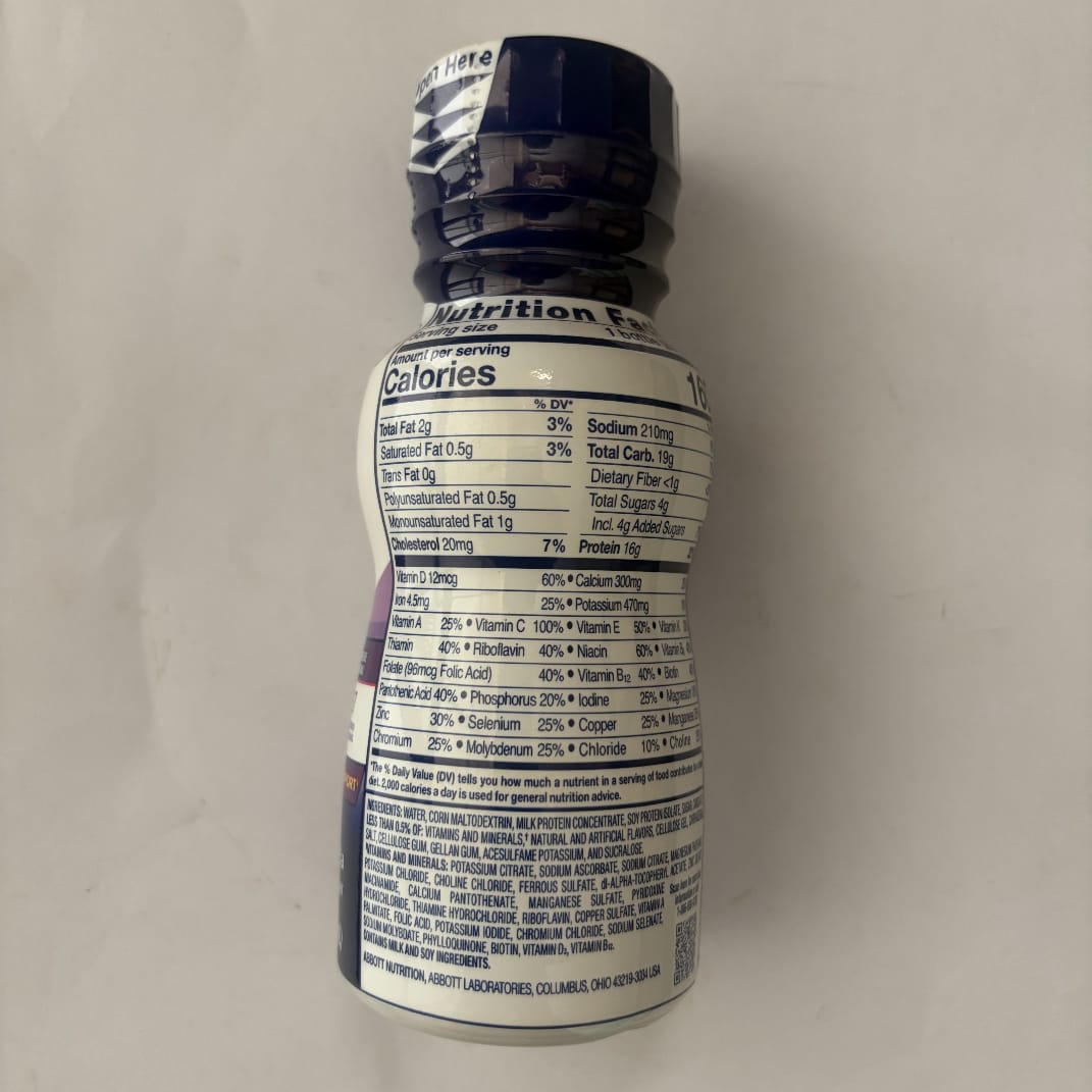Bottle with nutrition label on a plain background