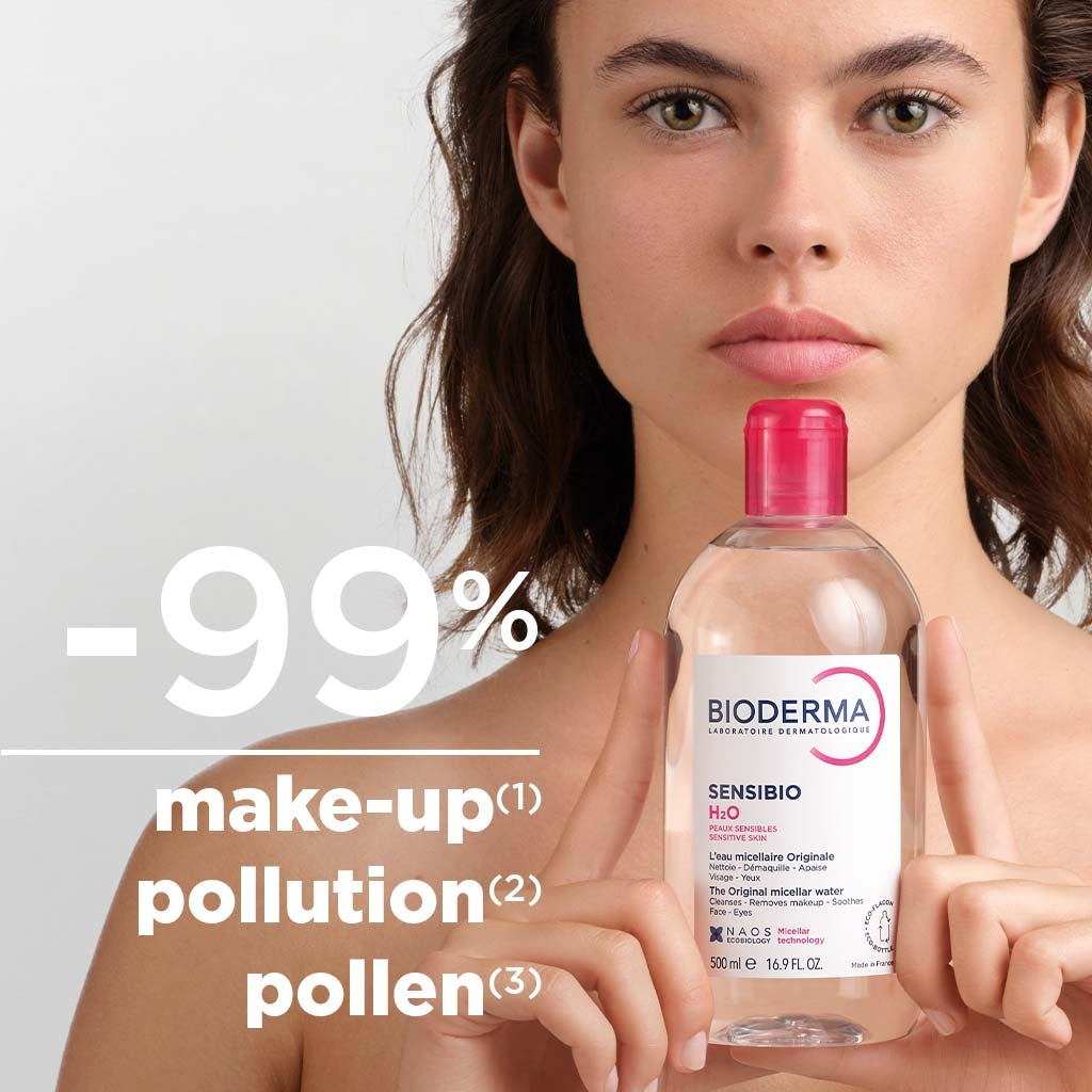 Woman holding a Bioderma bottle with text about makeup, pollution, and pollen reduction.