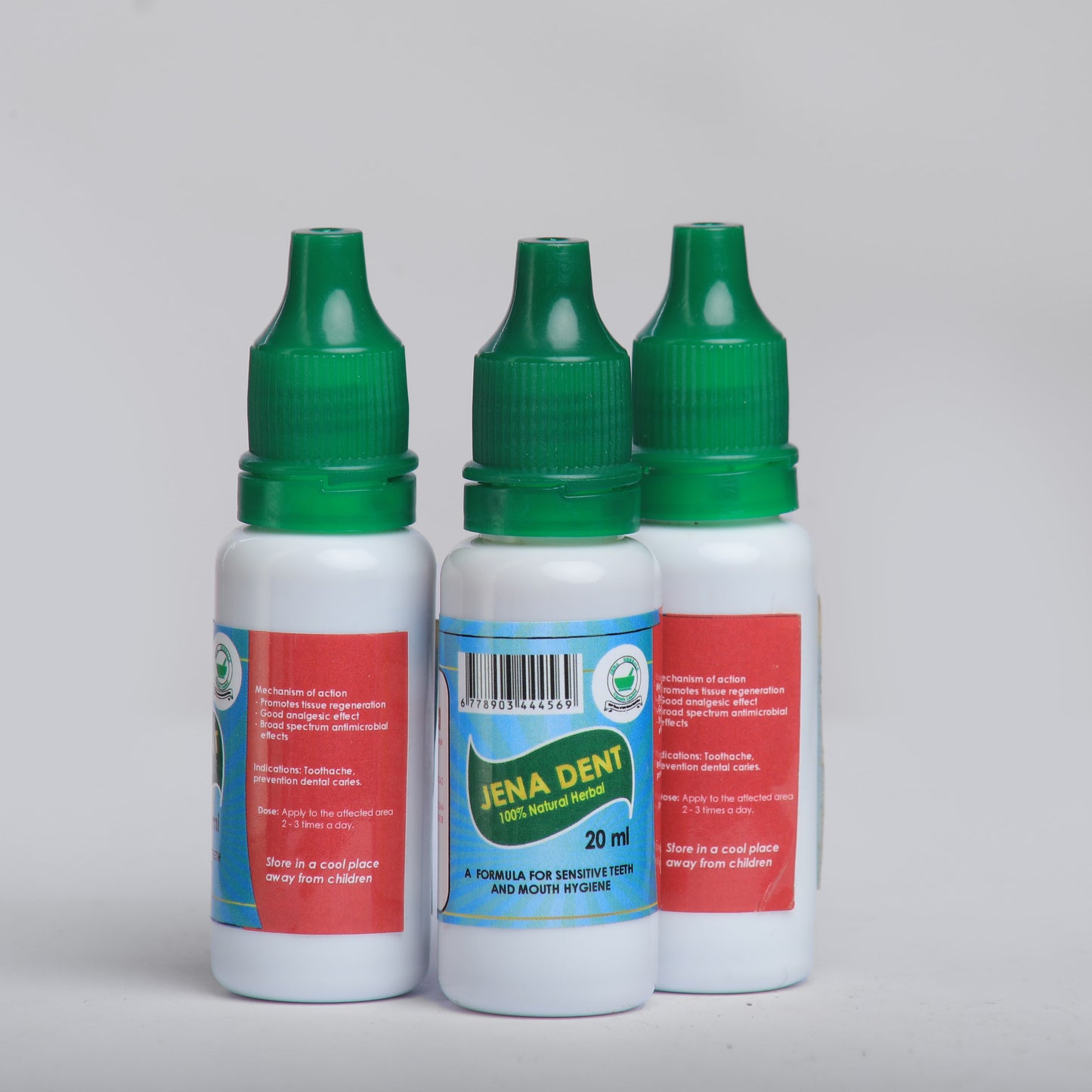 Three bottles of Jena Dent dental product on a gray background
