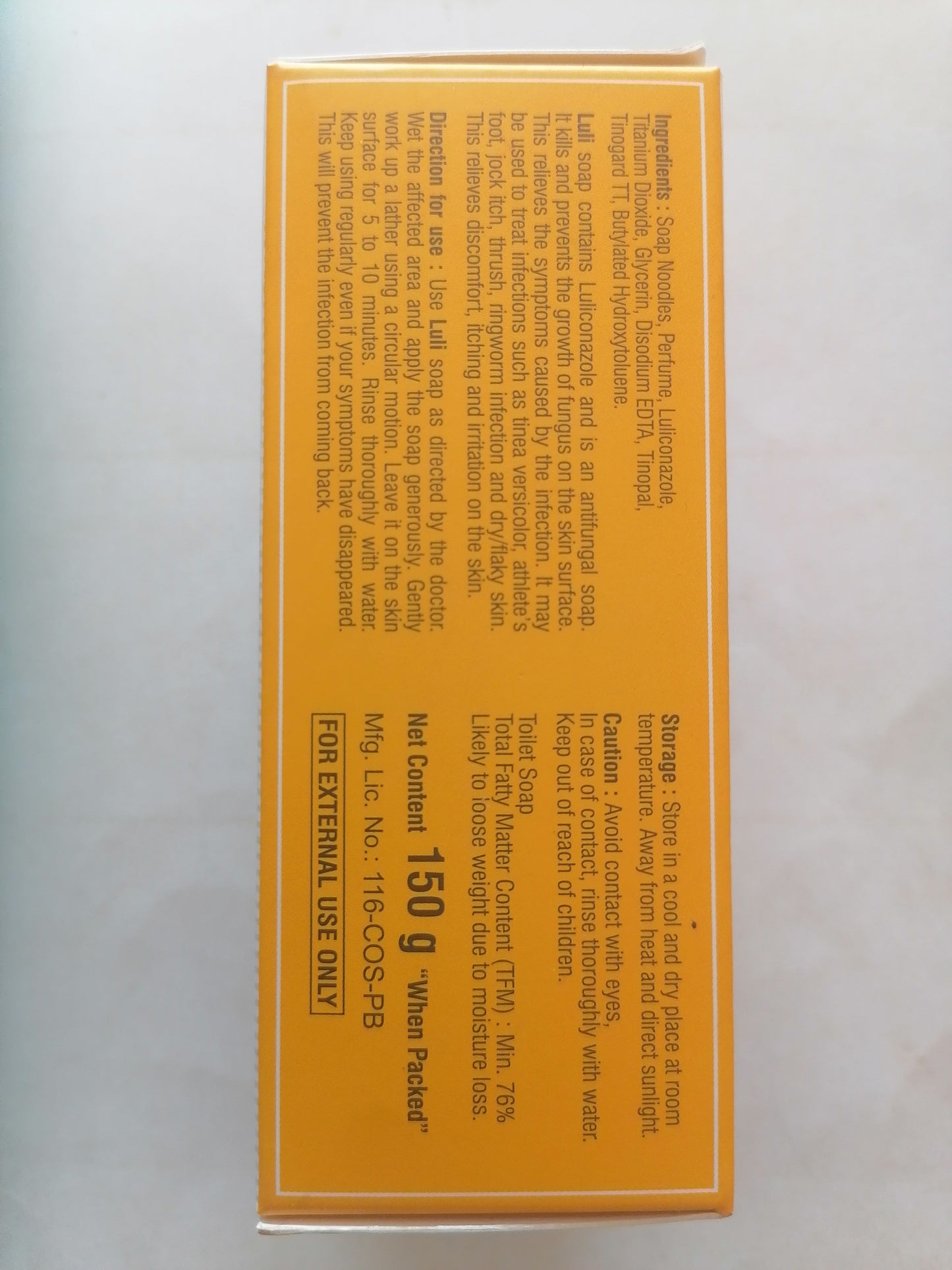 Bar of LULI soap next to its packaging on a white background