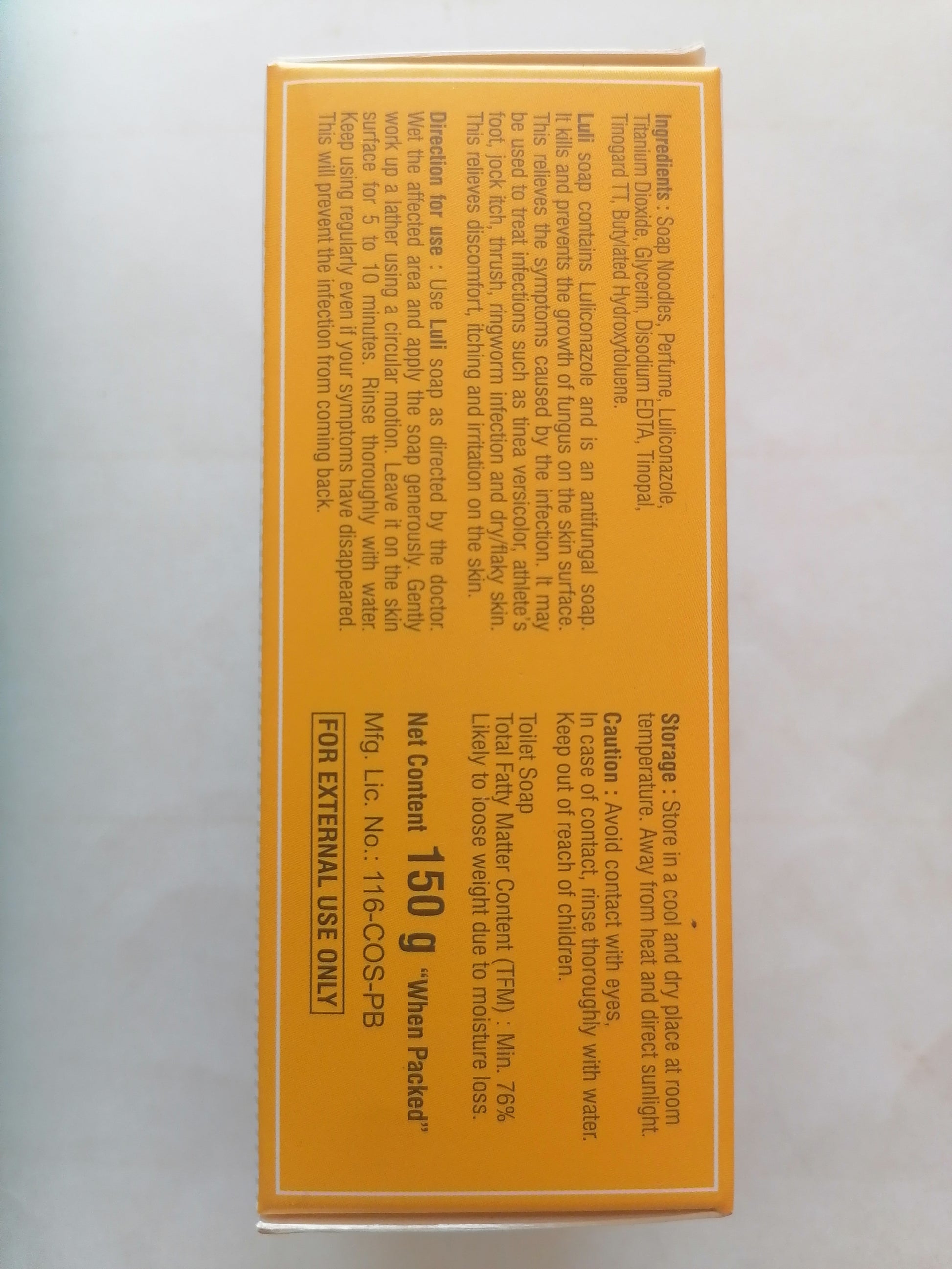 Bar of LULI soap next to its packaging on a white background