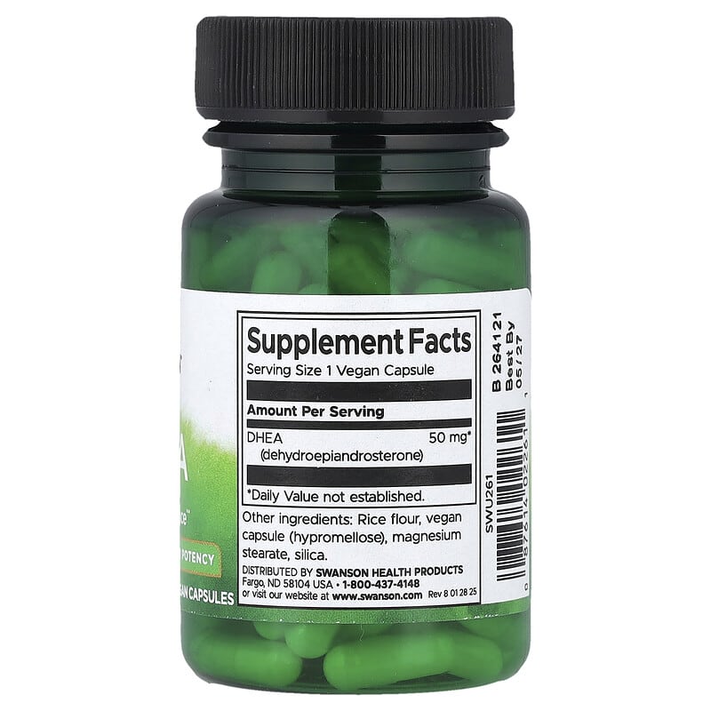 Supplement bottle with green capsules and a black lid on a white background
