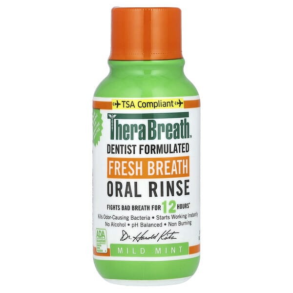 TheraBreath oral rinse bottle with green body and orange cap on a white background
