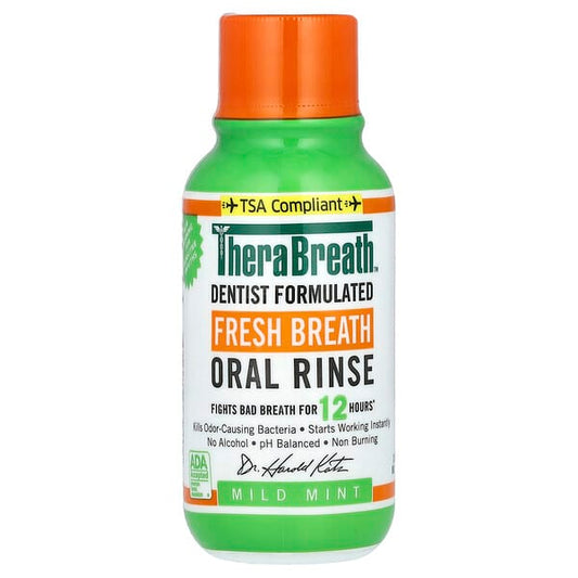 TheraBreath oral rinse bottle with green body and orange cap on a white background
