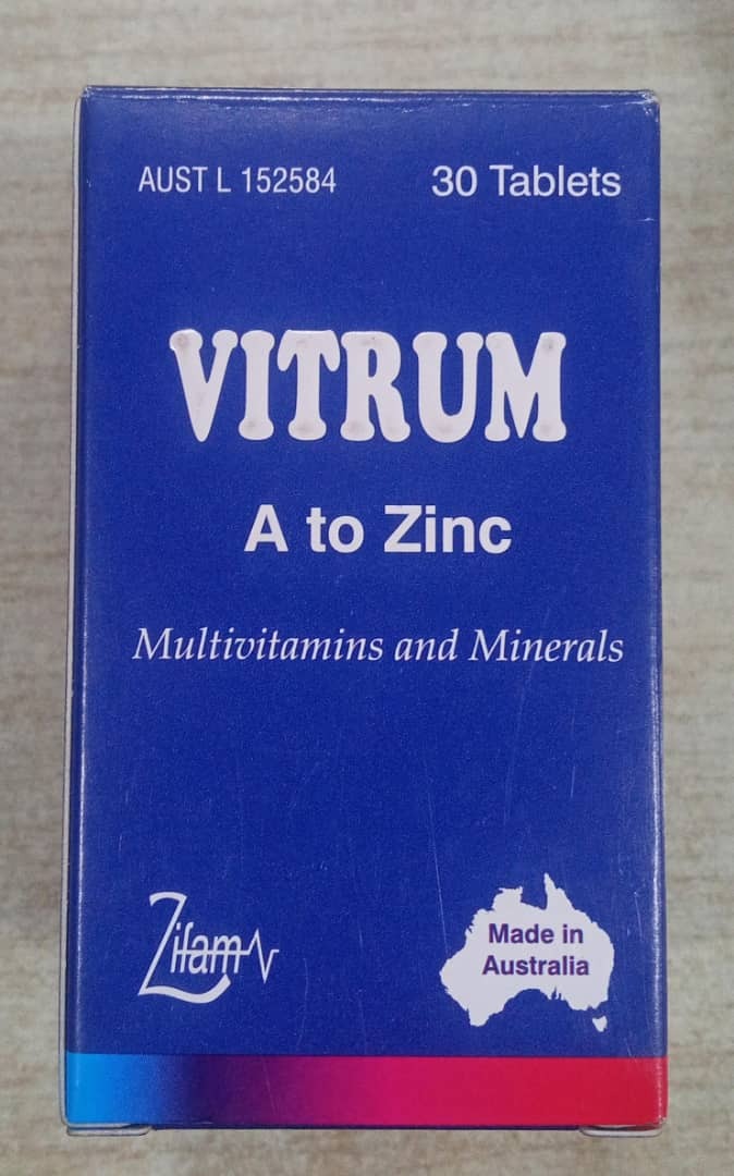Vitrum multivitamins and minerals packaging with blue and red design on a neutral background