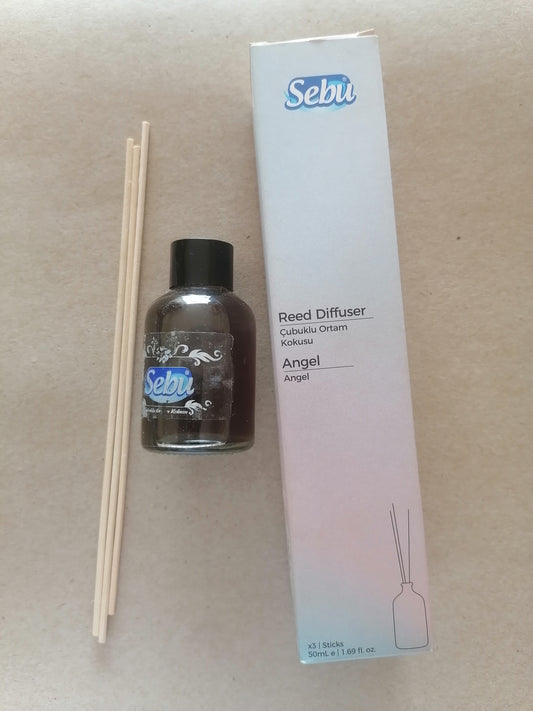 Sebu reed diffuser set with bottle, sticks, and packaging on a beige background